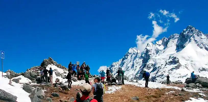 Salkantay Trek hikers at the highest pass surrounded by snow and ice in the Peruvian Andes