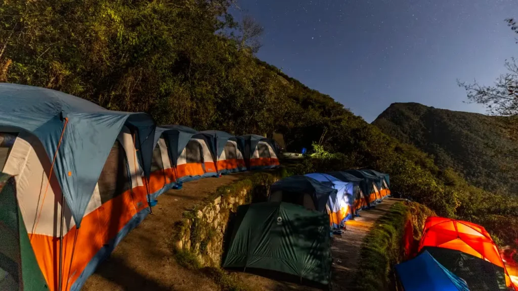 Short Inca Trail camping setup at Wiñay Wayna with mountain and cloud forest views