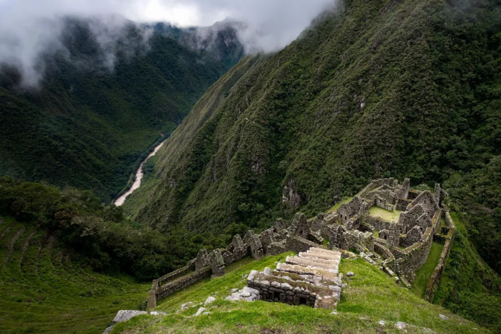 Short Inca Trail Wiñay Wayna ruins with stone terraces and cloud forest backdrop
